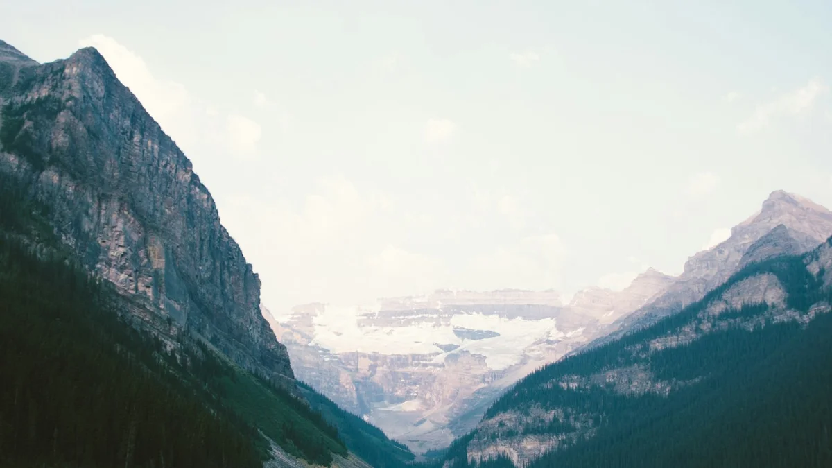 A mountain valley with a glacier and lake seen between forested slopes - a Quiet Core Reset guide to Your Body Is Talking - Here's What It's Saying.